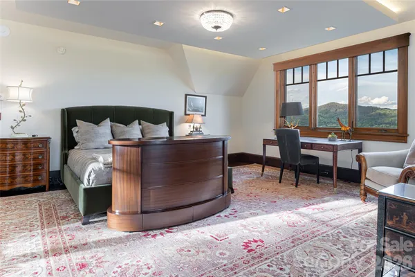 a living room with furniture and a floor to ceiling window