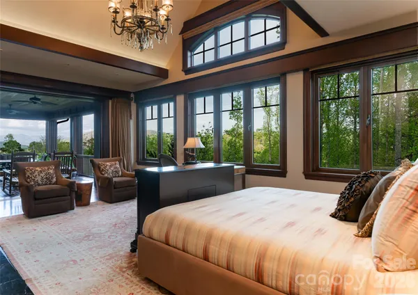 a bedroom with a large bed and a large window