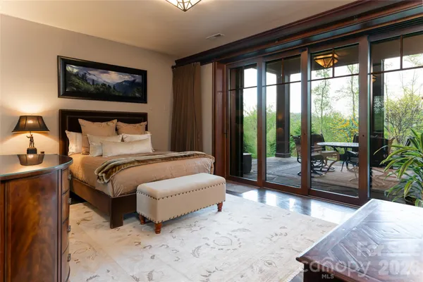 a bedroom with a large bed and a large window