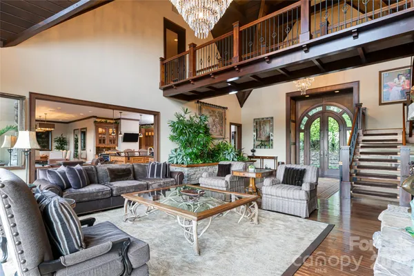 a living room with furniture a fireplace and a large window