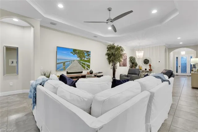 a living room with furniture and a chandelier