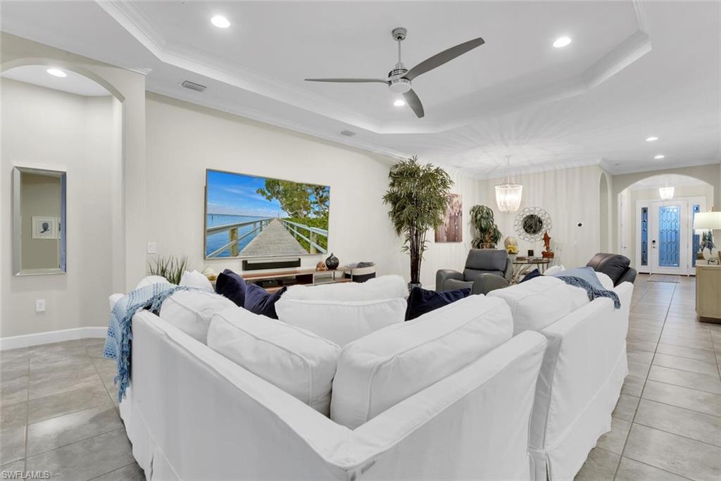 9630 Campanile Circle Naples, FL 34114 - Photo 12 of 31 a living room with furniture and a chandelier