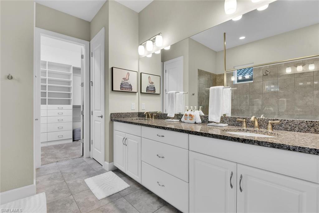 9630 Campanile Circle Naples, FL 34114 - Photo 17 of 31 a bathroom with a granite countertop sink mirror and double