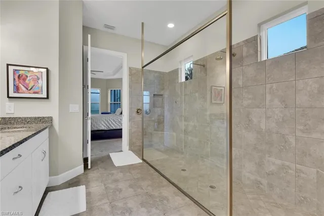 a bathroom with a granite countertop shower mirror and a sink