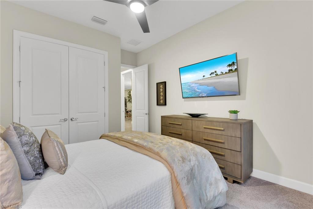 9630 Campanile Circle Naples, FL 34114 - Photo 21 of 31 a bedroom with a bed and a flat screen tv