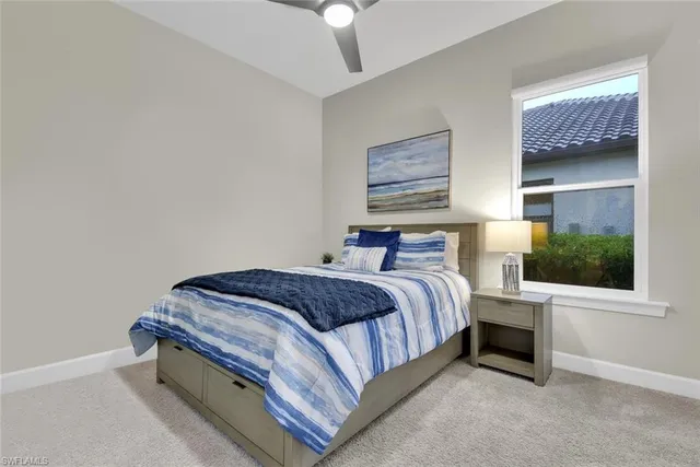 a bedroom with a bed lamp and a chandelier