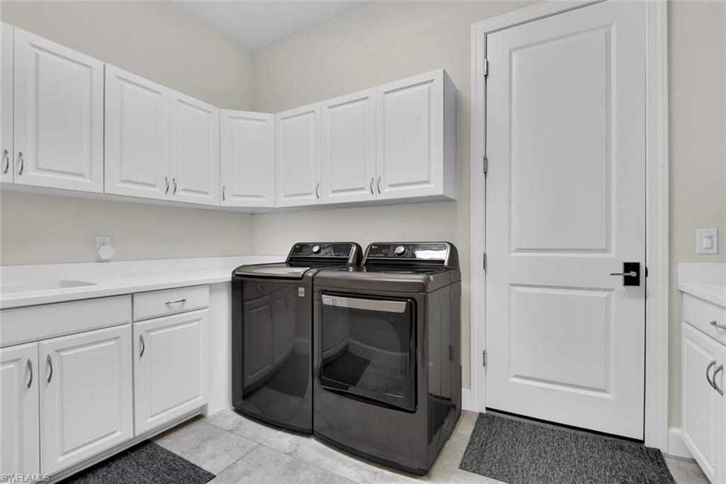 9630 Campanile Circle Naples, FL 34114 - Photo 26 of 31 a kitchen with granite countertop white cabinets and white appliances