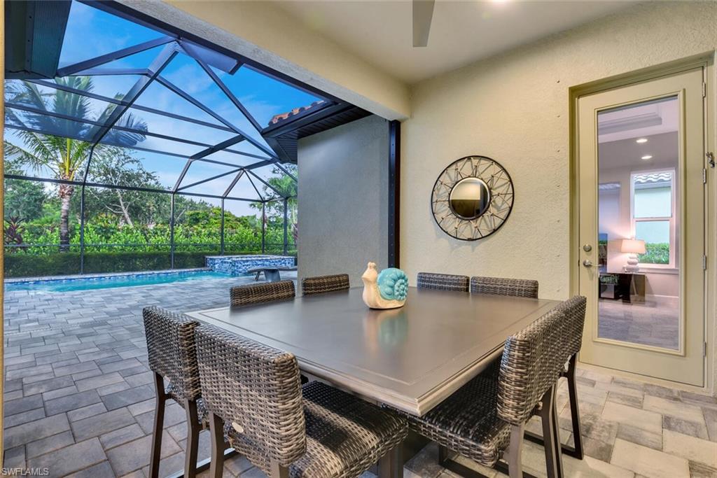 9630 Campanile Circle Naples, FL 34114 - Photo 29 of 31 a view of a dining table and chairs in a patio