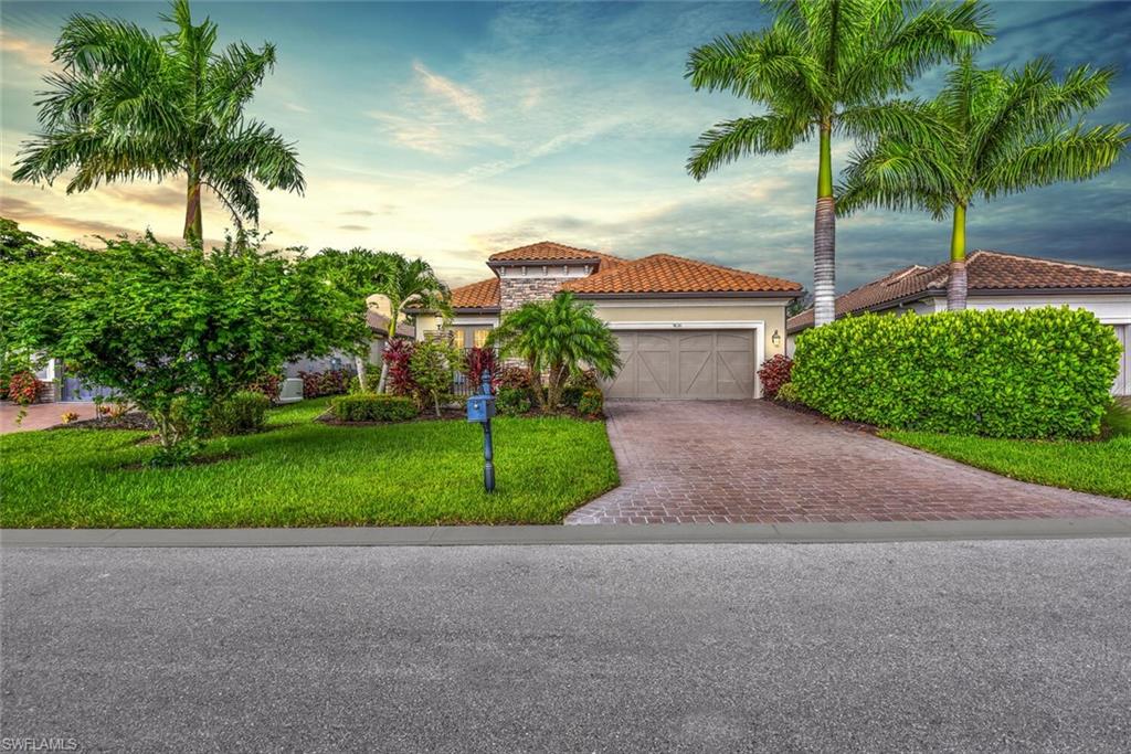 9630 Campanile Circle Naples, FL 34114 - Photo 3 of 31 a view of a house with a yard and palm trees