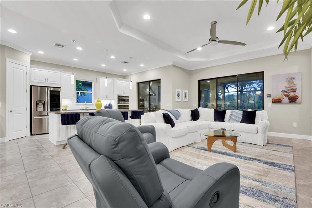 9630 Campanile Circle Naples, FL 34114 - Photo 6 of 31 a living room with furniture kitchen view and a large window