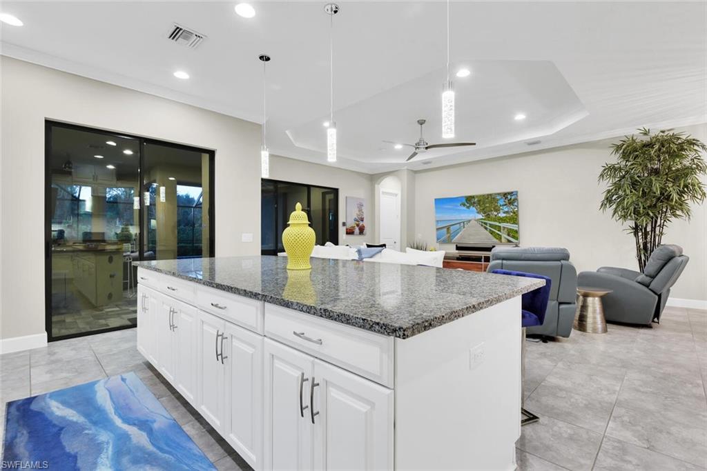 9630 Campanile Circle Naples, FL 34114 - Photo 8 of 31 a kitchen with stainless steel appliances granite countertop a sink a counter top space and living room view