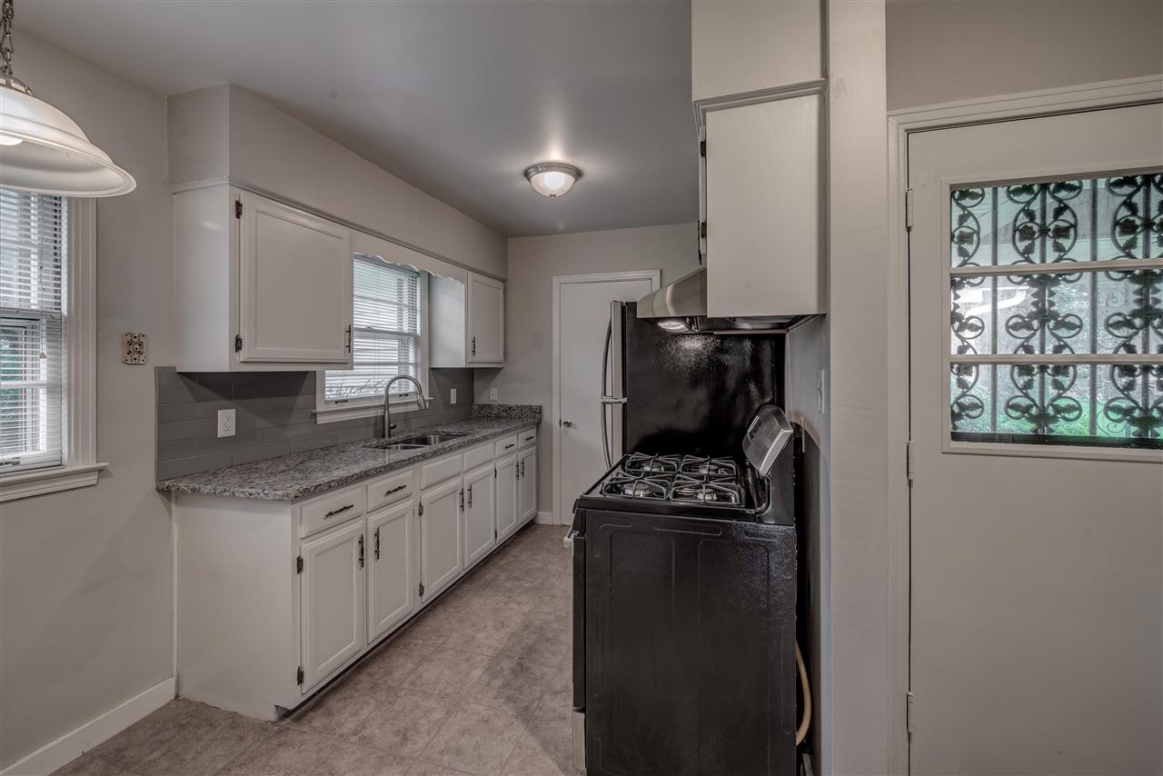 1645 Welsh Road Memphis, TN 38117 - Photo 11 of 18 a kitchen with a refrigerator a stove a sink and a window