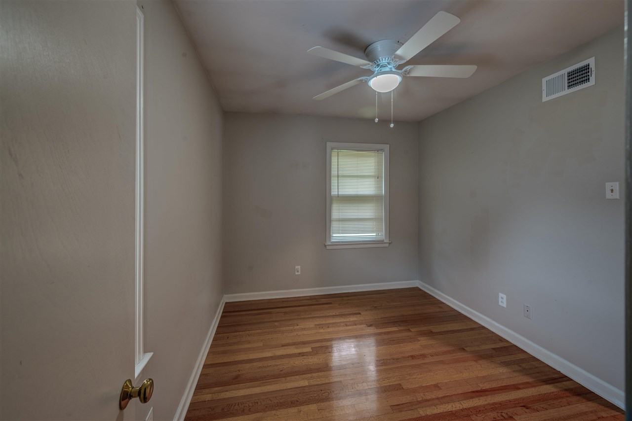 1645 Welsh Road Memphis, TN 38117 - Photo 13 of 18 a view of an empty room with wooden floor and a window