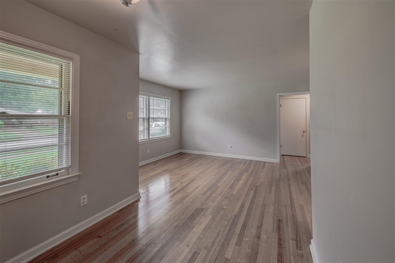 1645 Welsh Road Memphis, TN 38117 - Photo 5 of 18 a view of an empty room with wooden floor and a window