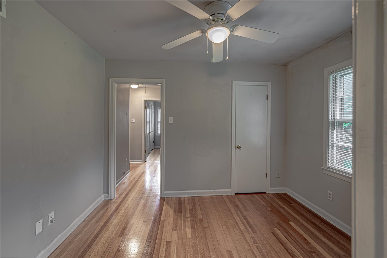 1645 Welsh Road Memphis, TN 38117 - Photo 6 of 18 a view of an empty room with wooden floor and a window