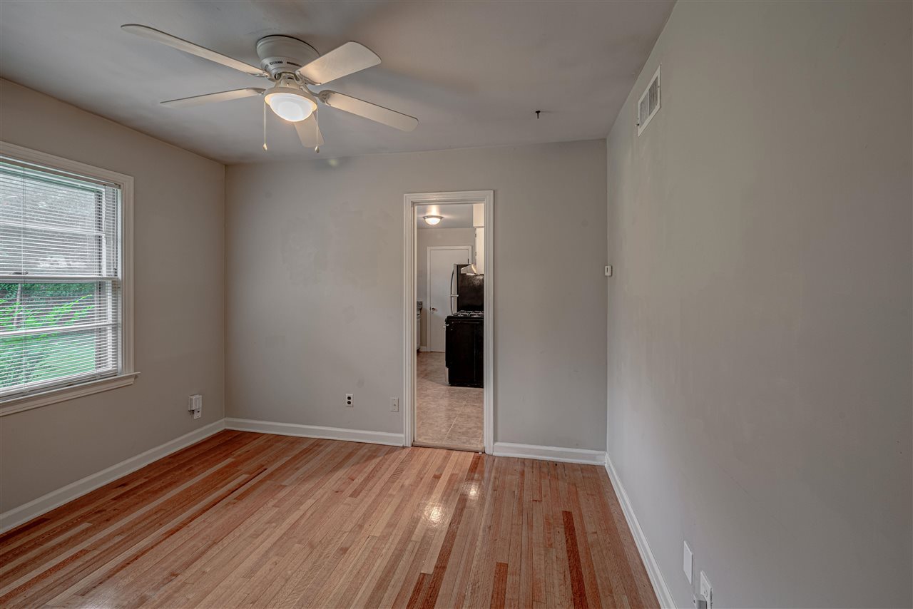 1645 Welsh Road Memphis, TN 38117 - Photo 7 of 18 wooden floor in an empty room with a window