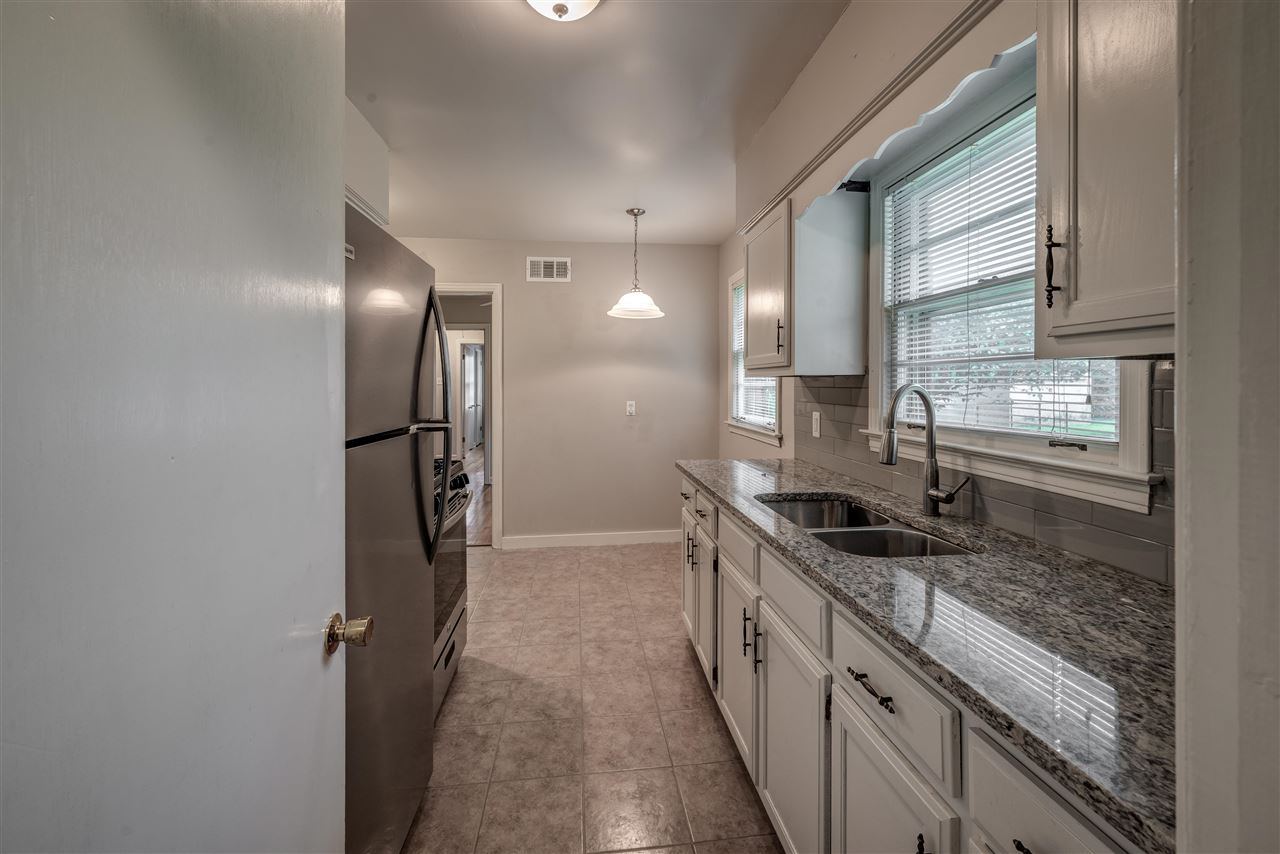 1645 Welsh Road Memphis, TN 38117 - Photo 9 of 18 a kitchen with stainless steel appliances granite countertop a sink and a refrigerator