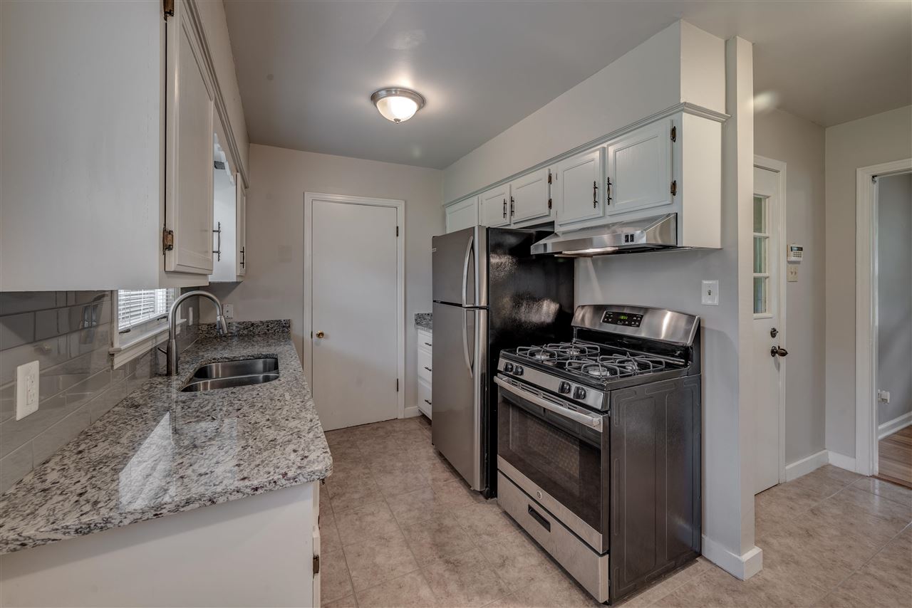1645 Welsh Road Memphis, TN 38117 - Photo 10 of 18 a kitchen with granite countertop a sink stove and refrigerator