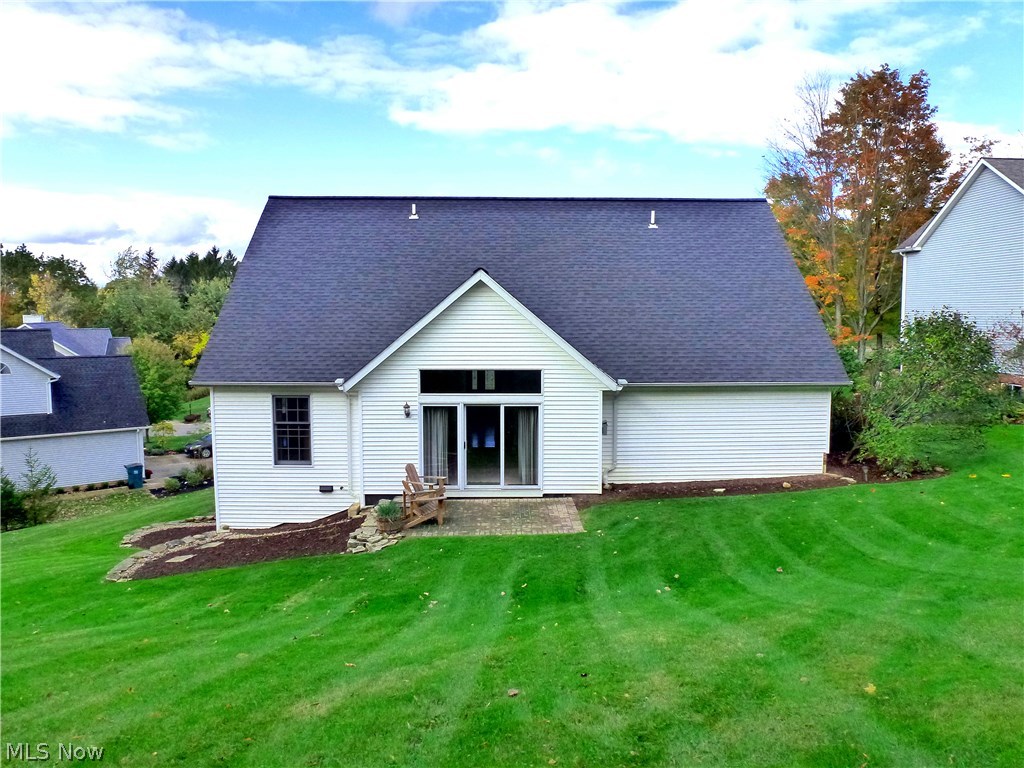13591 Spring Street Burton, OH 44021 - Photo 2 of 25 Rear view with Sliding Door from vaulted ceiling Family Room leading to a 13' x 9' Paver Stone patio.