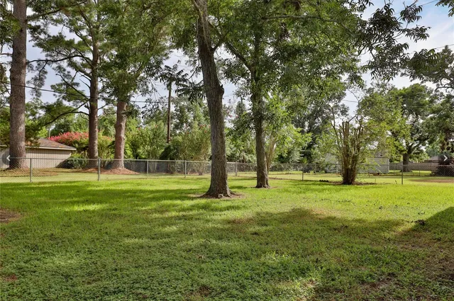 a view of grassy field with trees