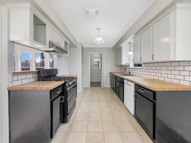 a kitchen with stainless steel appliances granite countertop a stove and a sink
