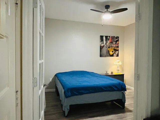 a room with a bed and painting on the wall