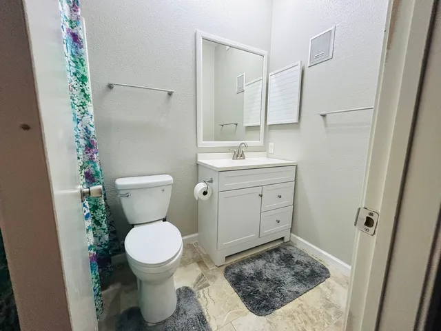 a bathroom with a toilet and a sink