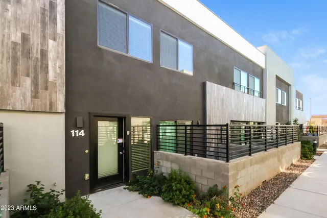 a front view of a house with large windows