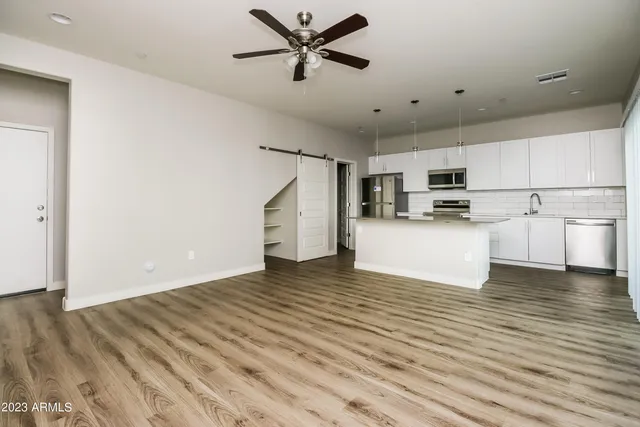a view of a kitchen with microwave and cabinets