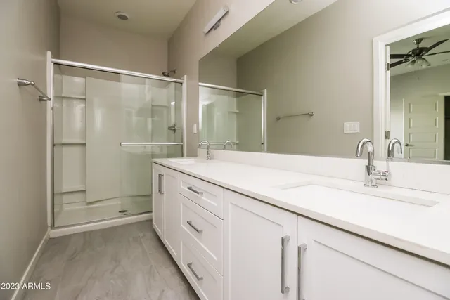 a bathroom with a shower sink and mirror