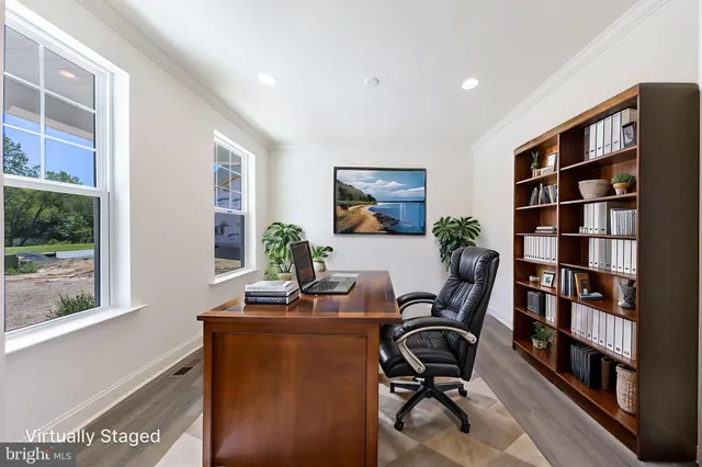 a view of a workspace with furniture and a book shelf
