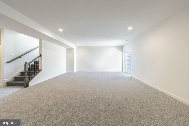 a view of an empty room with stairs