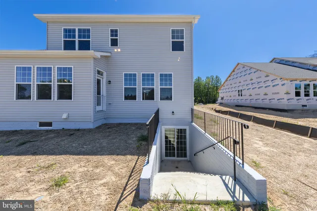 a view of a house with wooden fence