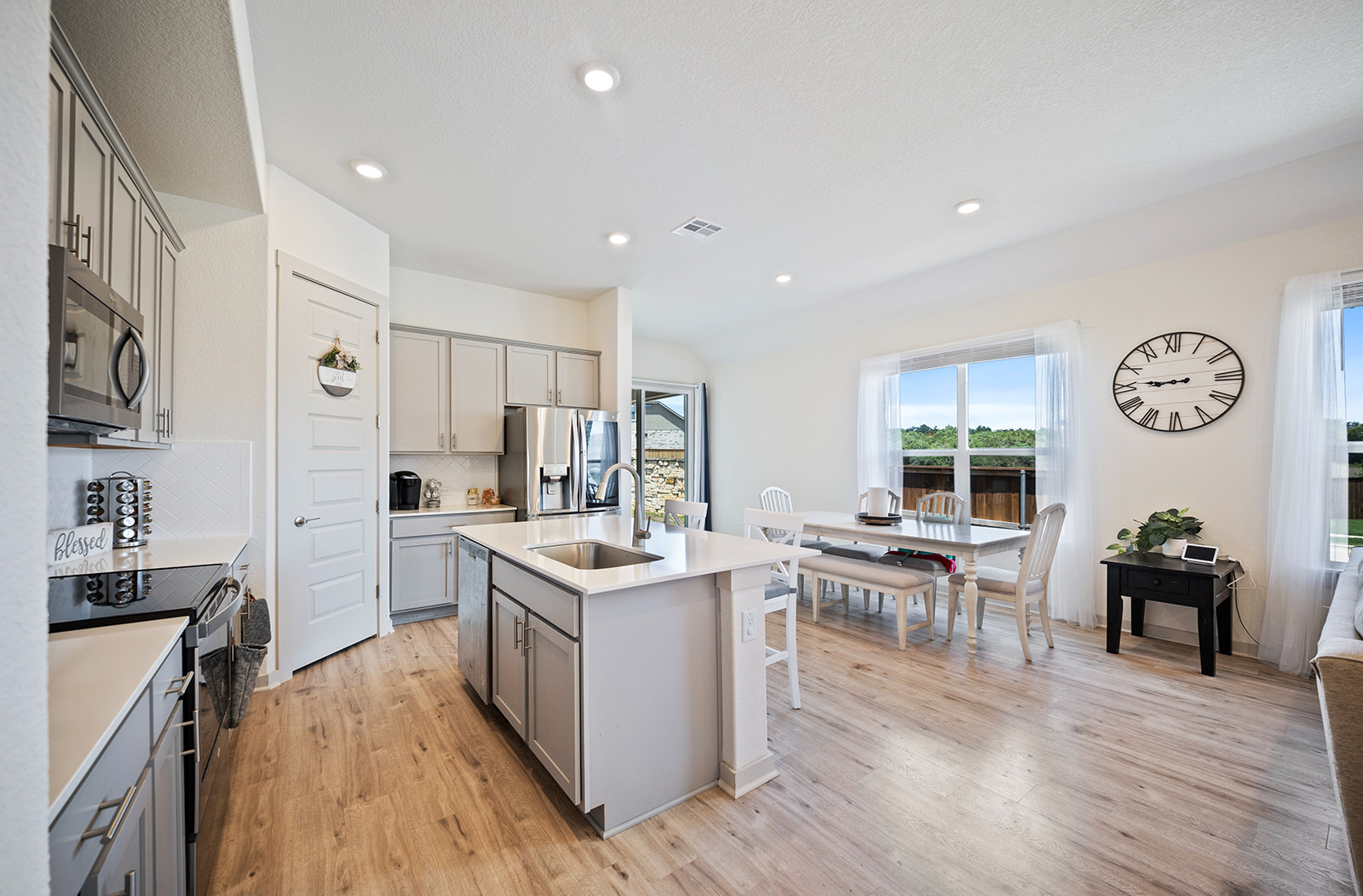 900 Balsora Cove Georgetown, TX 78628 - Photo 8 of 39 A well-lit, open-concept kitchen and dining area provides ample space for everyday living and entertaining.