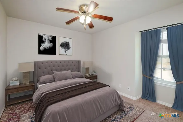 a bedroom with a large bed and a window