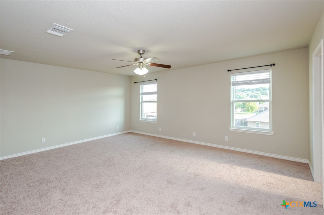 2601 Tarrant County Drive Killeen, TX 76549 - Photo 23 of 35 an empty room with windows and fan