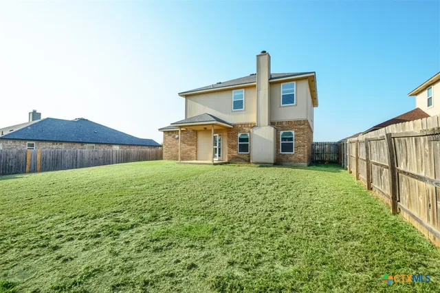 a view of a house with backyard and garage