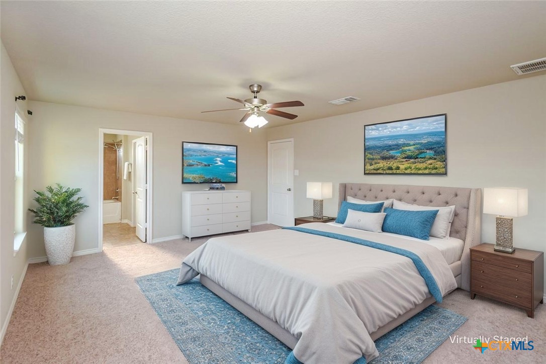 2601 Tarrant County Drive Killeen, TX 76549 - Photo 8 of 35 a spacious bedroom with a bed and a chandelier