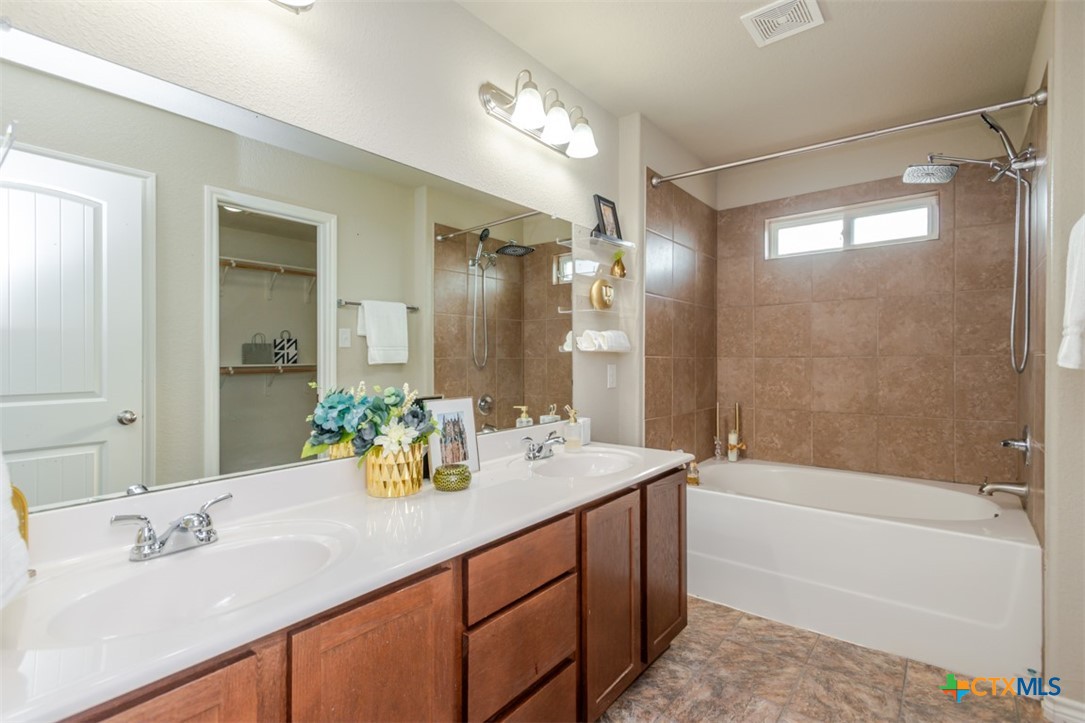2601 Tarrant County Drive Killeen, TX 76549 - Photo 10 of 35 a bathroom with a tub sink shower and a mirror
