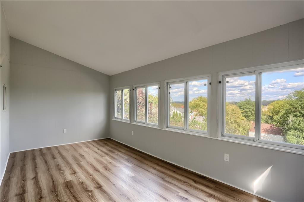 96 Ridgewood Avenue Pittsburgh, PA 15229 - Photo 19 of 41 Main floor family room with lots of windows and a new laminate floor.