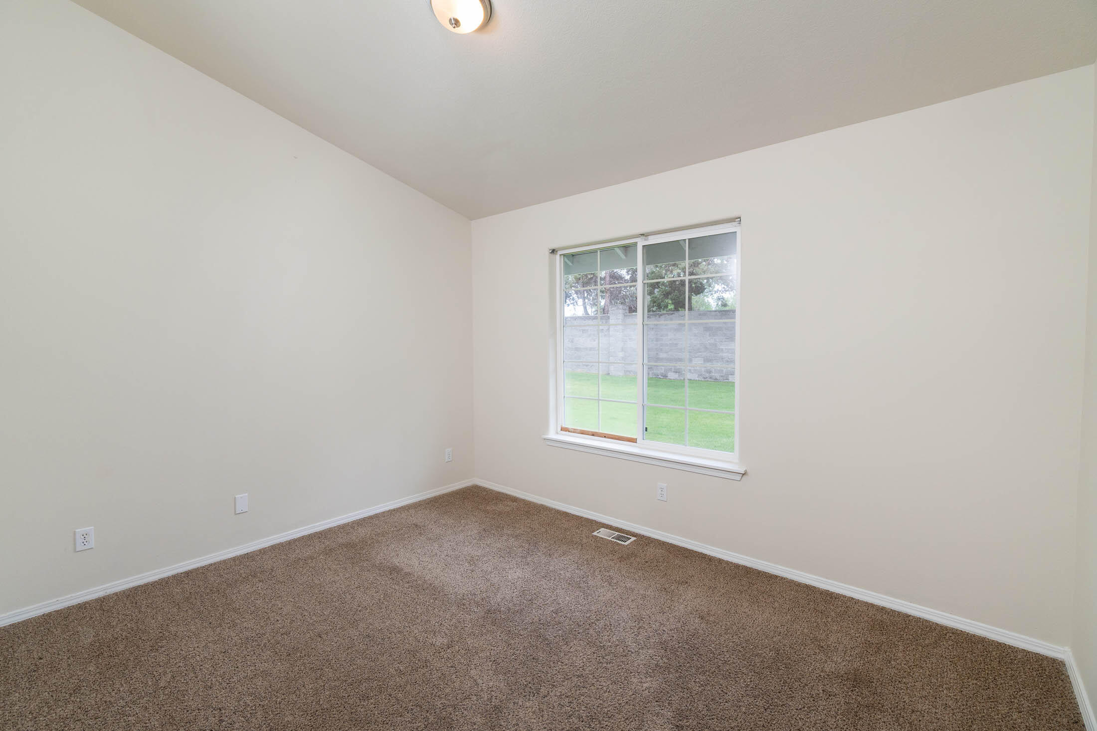 3389 Northeast Stonebrook Loop Bend, OR 97701 - Photo 12 of 27 Spacious second bedroom with vaulted ceiling.