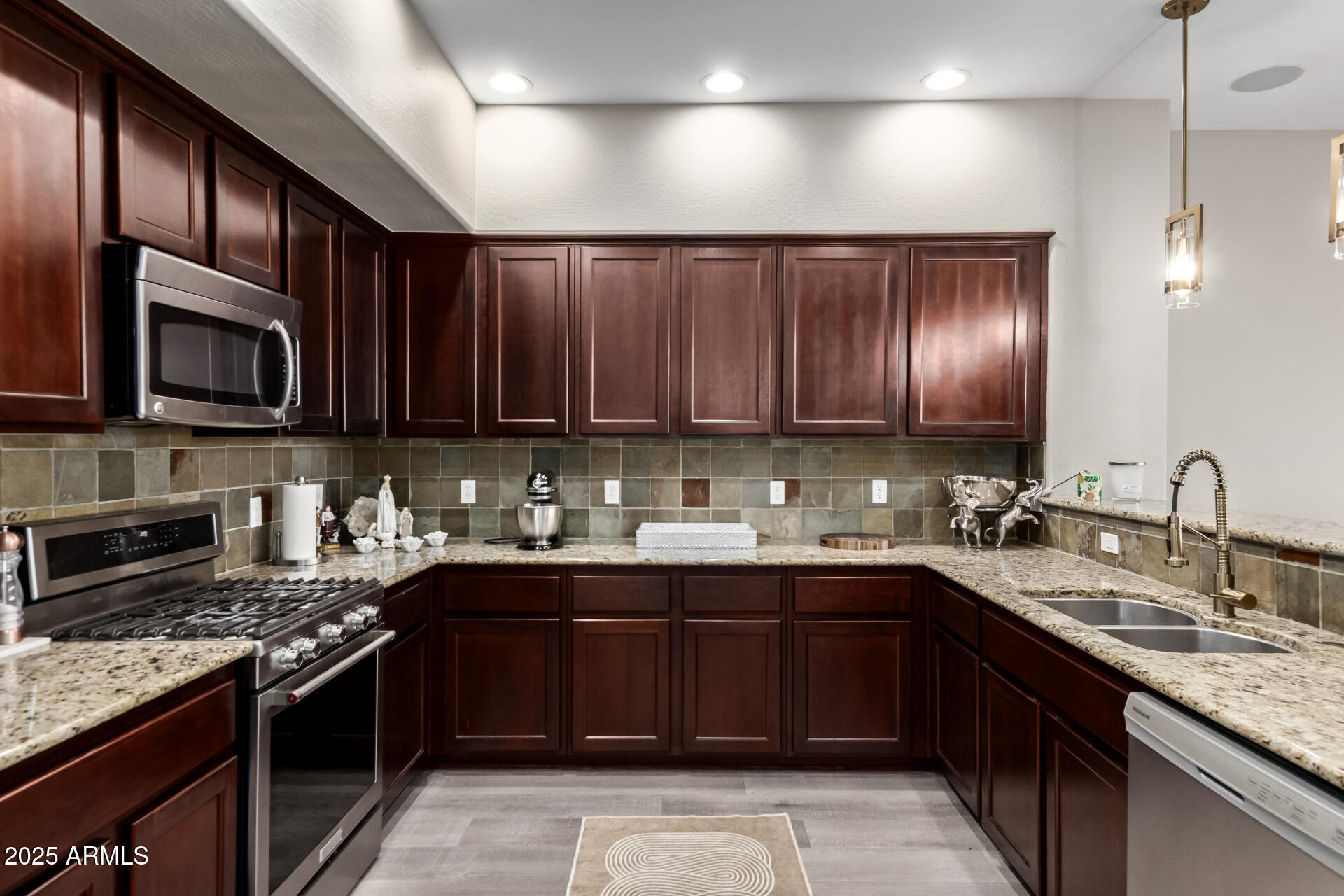 4777 South Fulton Ranch Boulevard, Unit 2035 Chandler, AZ 85248 - Photo 12 of 38 a kitchen with a sink stove top oven and microwave