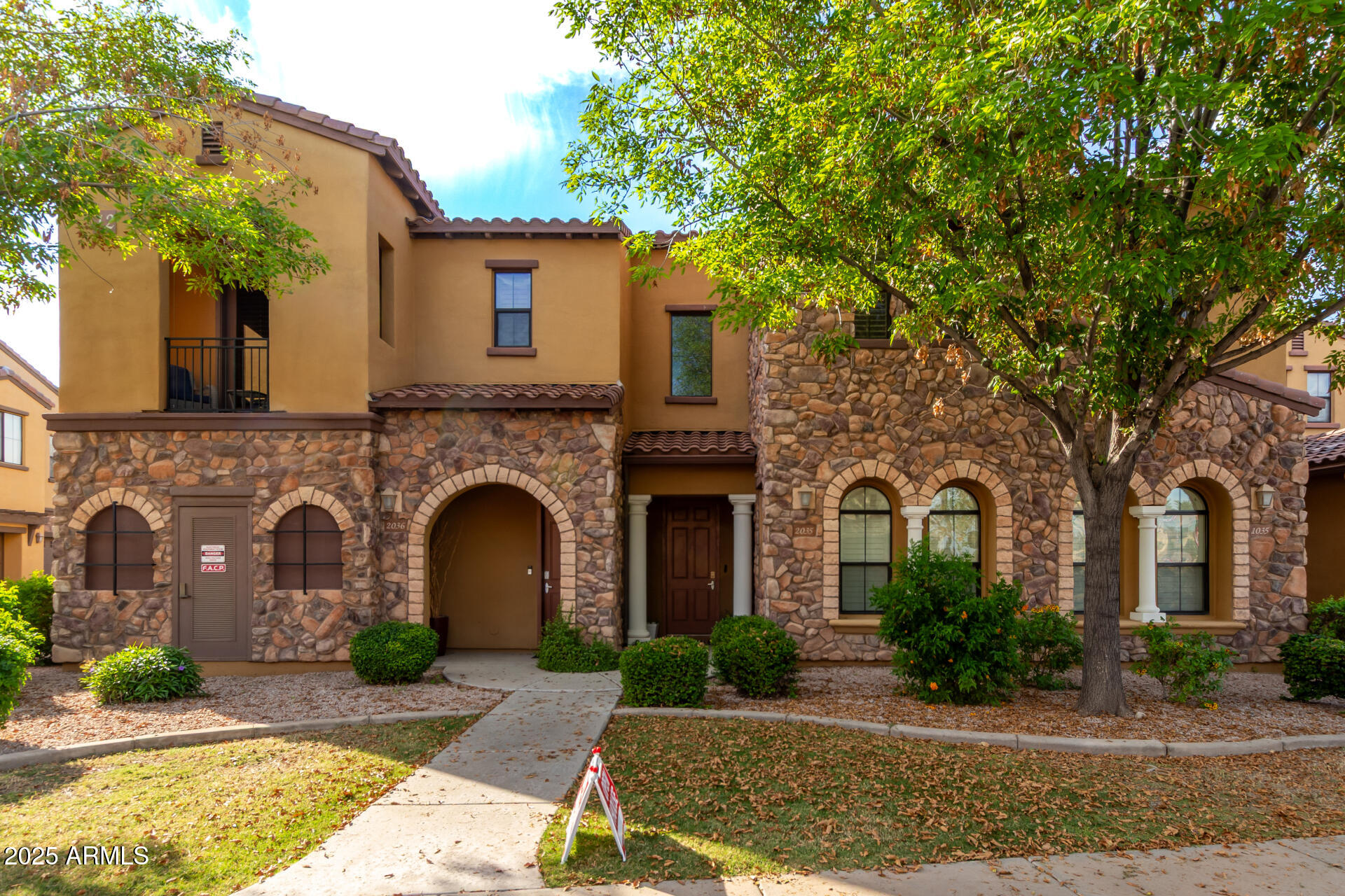 4777 South Fulton Ranch Boulevard, Unit 2035 Chandler, AZ 85248 - Photo 2 of 38 a front view of a house with yard