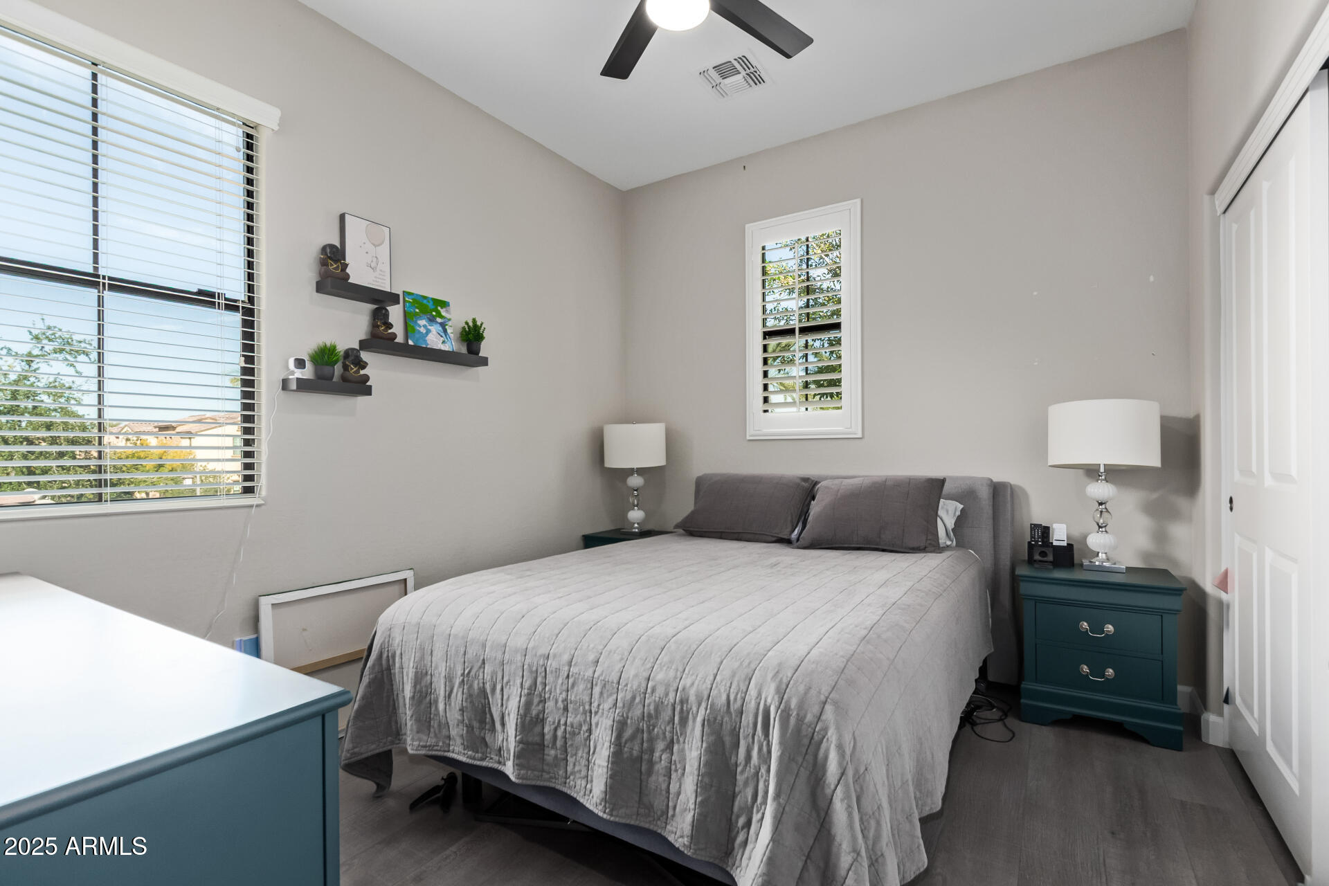 4777 South Fulton Ranch Boulevard, Unit 2035 Chandler, AZ 85248 - Photo 21 of 38 a bedroom with a bed and a lamp