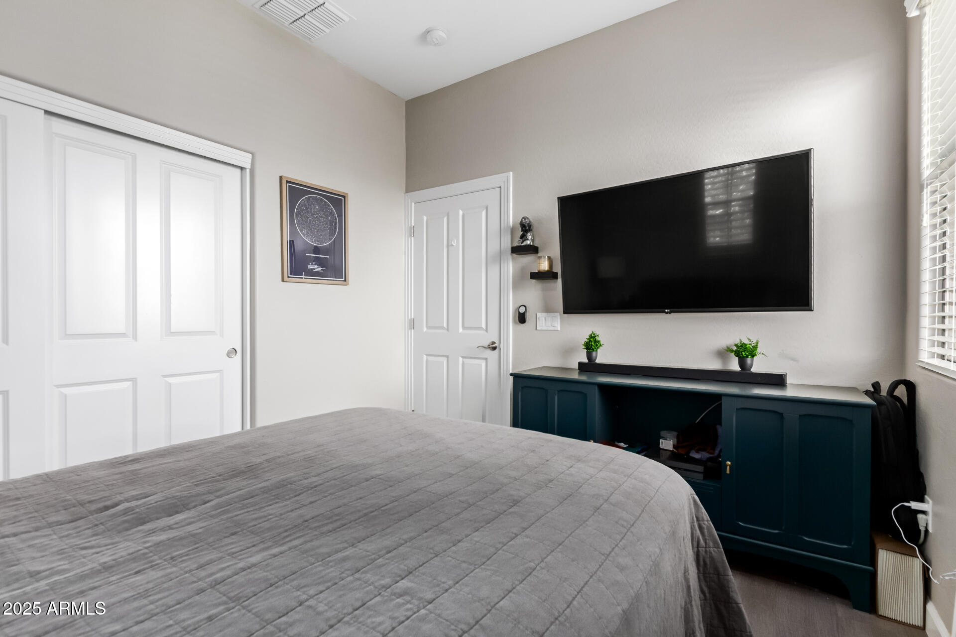 4777 South Fulton Ranch Boulevard, Unit 2035 Chandler, AZ 85248 - Photo 22 of 38 a bedroom with a bed and a flat screen tv