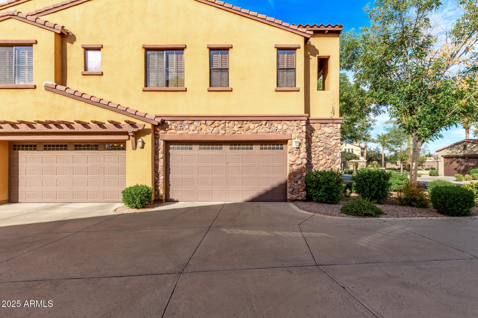 4777 South Fulton Ranch Boulevard, Unit 2035 Chandler, AZ 85248 - Photo 30 of 38 a front view of a house with a yard and a garage