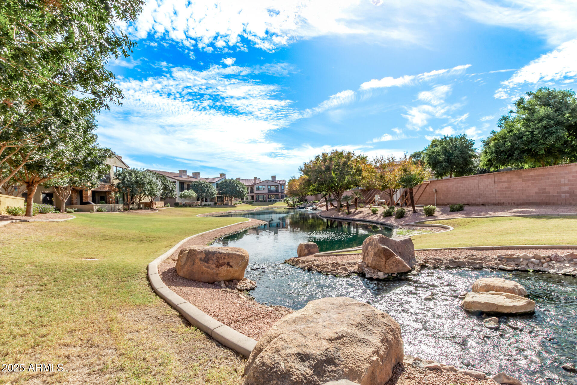 4777 South Fulton Ranch Boulevard, Unit 2035 Chandler, AZ 85248 - Photo 35 of 38 a view of a lake with a swimming pool and a yard