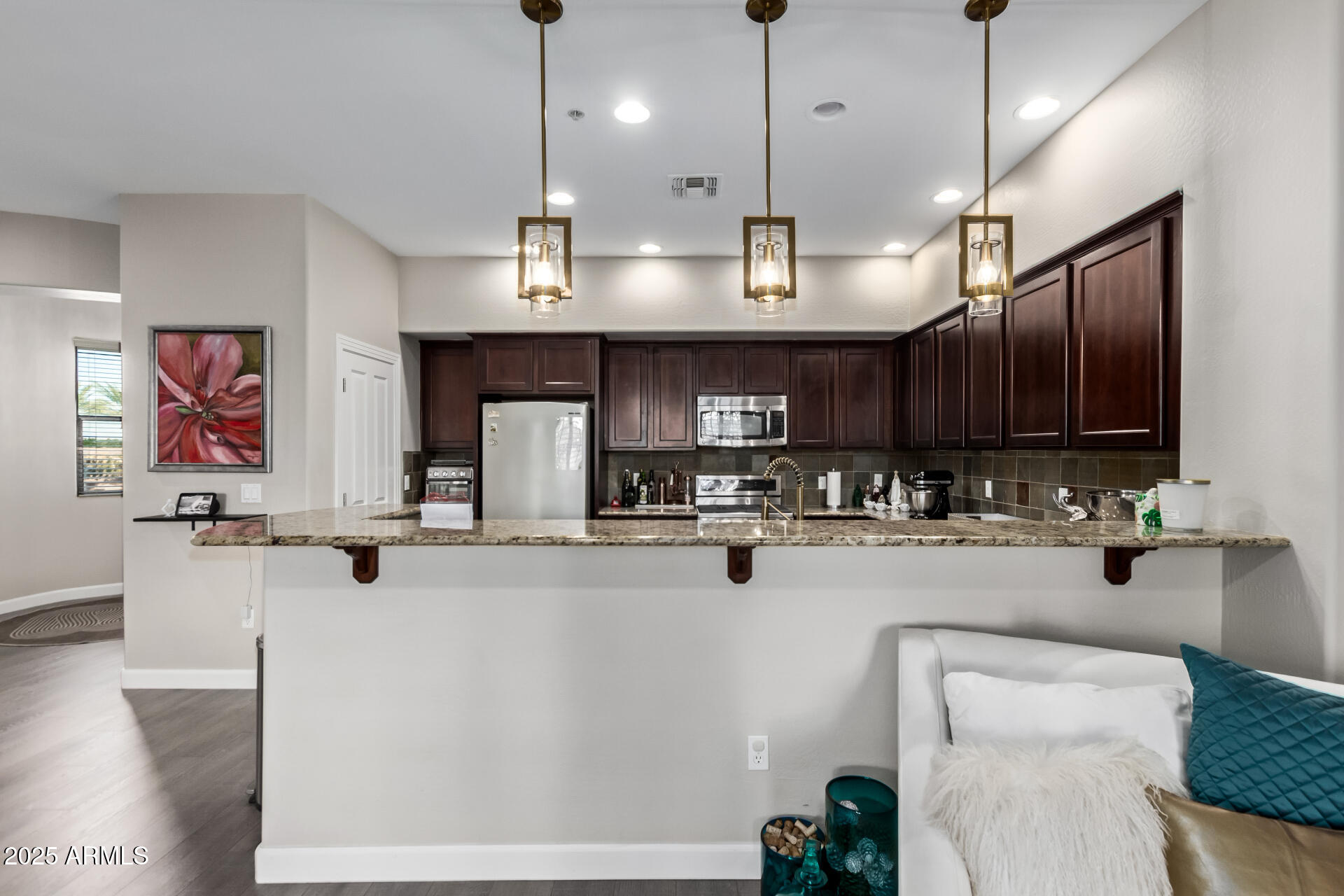 4777 South Fulton Ranch Boulevard, Unit 2035 Chandler, AZ 85248 - Photo 10 of 38 a view of a kitchen with kitchen island a large counter top space appliances and cabinets