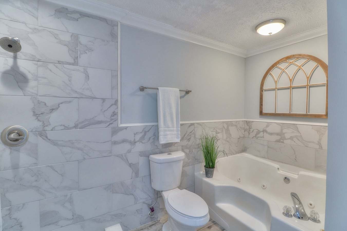 2891 Sulphur Springs Road Murfreesboro, TN 37129 - Photo 26 of 31 a white toilet sitting next to a bath tub and a shower