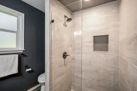 a bathroom with a shower toilet and sink